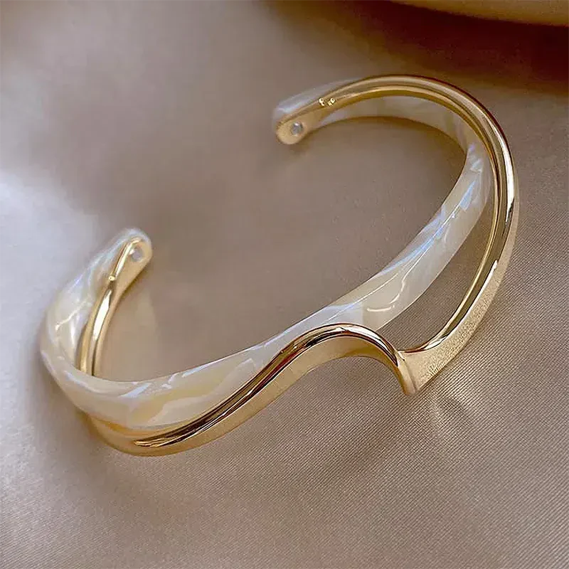エレガントな白エナメルと金のオープンブレスレット
